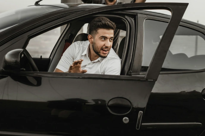 a person sitting on the seat of a car